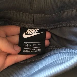 Grey Nike sportswear tech joggers with stripe